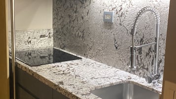 Microwave, dishwasher, coffee/tea maker, cookware/dishes/utensils