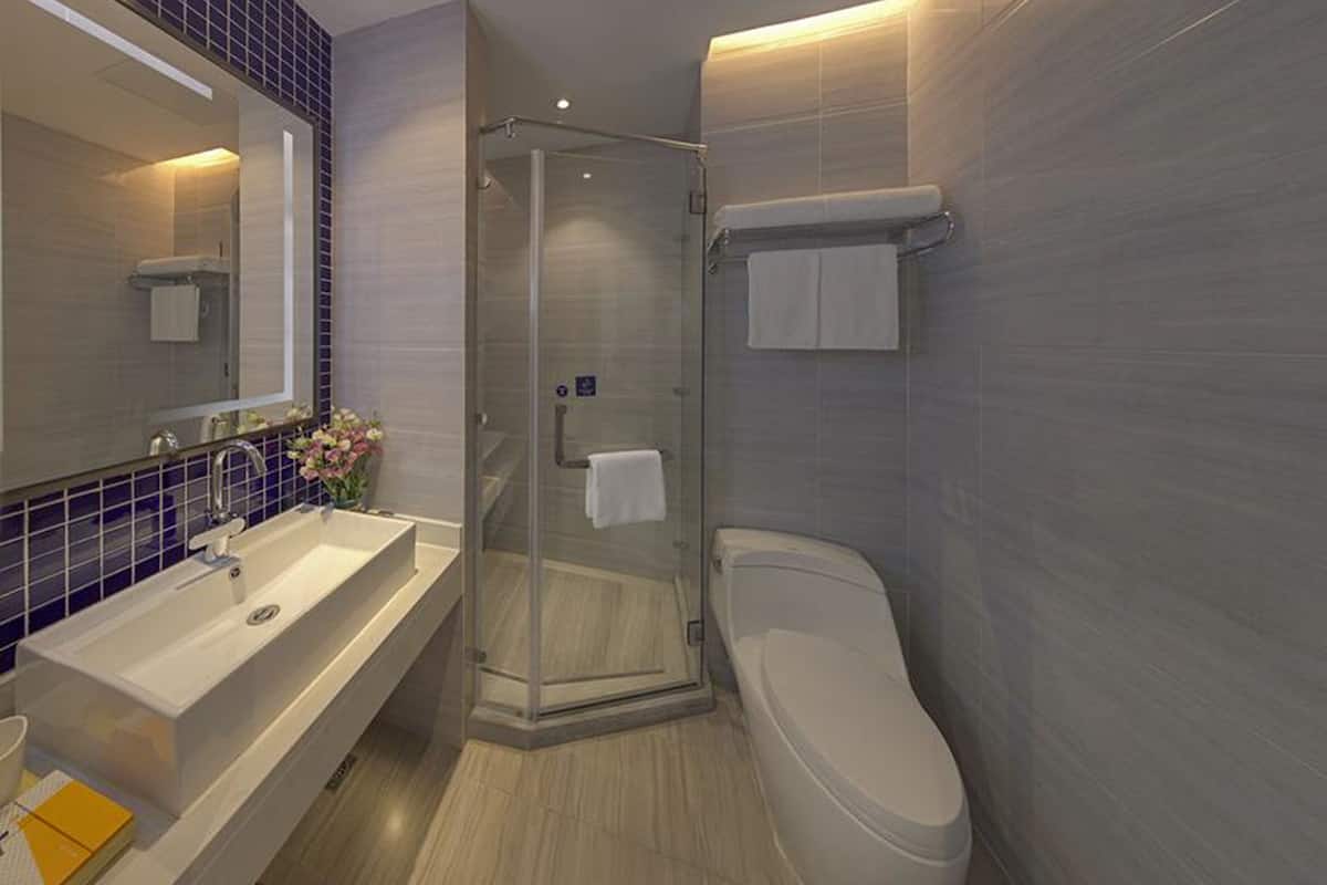 shower, hair dryer, slippers, towels