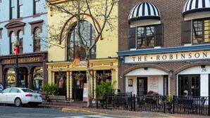 A street view with buildings including a restaurant named 'The Robinson' and another with a sign 'Patricia'.