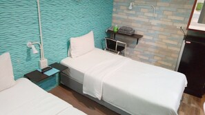 A hotel room with a bed, bedside table, and a small shelf with toiletries. - 14 Plus 1 Hotel (Bangkok)
