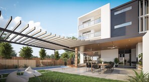 A modern building with a covered outdoor area, a pool, and outdoor seating. - The Beach Oasis | DUNE (Kingscliff)