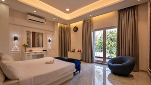 A modern hotel room with a bed, a chair, a desk, and a window with curtains. - U Rivergate Resort & Spa, Karjat (Karjat)