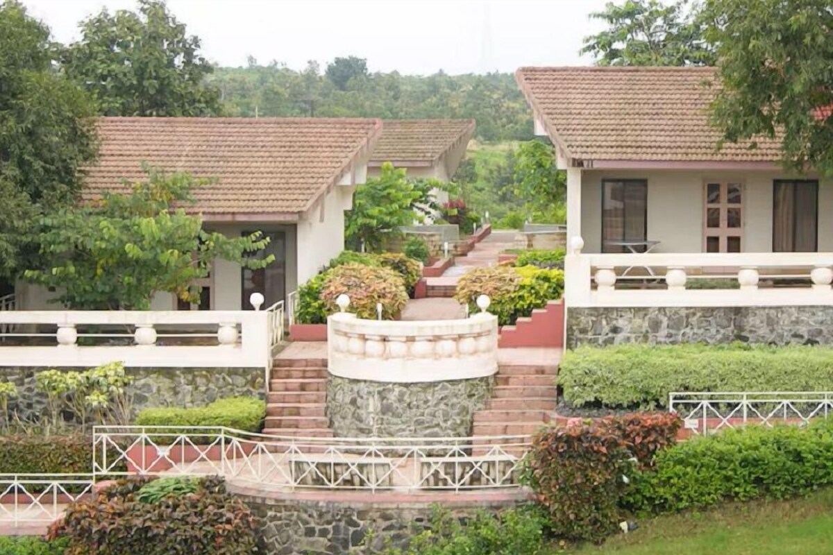 A residential area with multiple houses, a stone staircase, and a white railing.