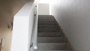 A staircase with a handrail and a light source at the top. - Mango Resort Okinawa Naha (Naha)