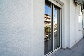 A building exterior with a large glass door and a white wall. - The Flirty Athens (Kallithea)