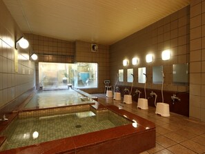 A sauna with multiple hot tubs and individual shower stalls. - Kouchiso (Koshu)