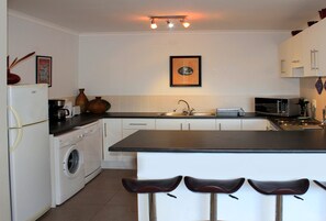Apartment, 2 Bedrooms, Balcony | Private kitchen | Full-size fridge, microwave, oven, stovetop - Beachside Villa Muizenberg Beachfront (Cape Town)