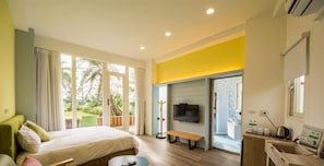 A modern hotel room with a bed, a bench, a TV, and a view of the outdoors. - The Riverview Retreats (Wujie)