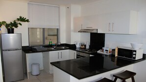 Apartment, 1 Bedroom | Private kitchen | Full-size fridge, microwave, oven, stovetop - Melrose Place Muizenberg Beachfront (Cape Town)