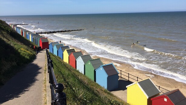 A seaside promenade with colorful beach huts along the path. - Spacious barn, seals, seaside walks and Broads National Park (Great Yarmouth)