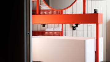 A bunk bed with a round mirror and a white sink.