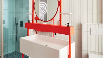 Bathroom features a sink, mirror, glass shower enclosure, and toilet.