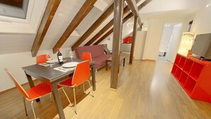 A dining area with a table, chairs, and a bottle of wine. - ZH Strawberry - Oerlikon Hitrental Apartment (Zürich)