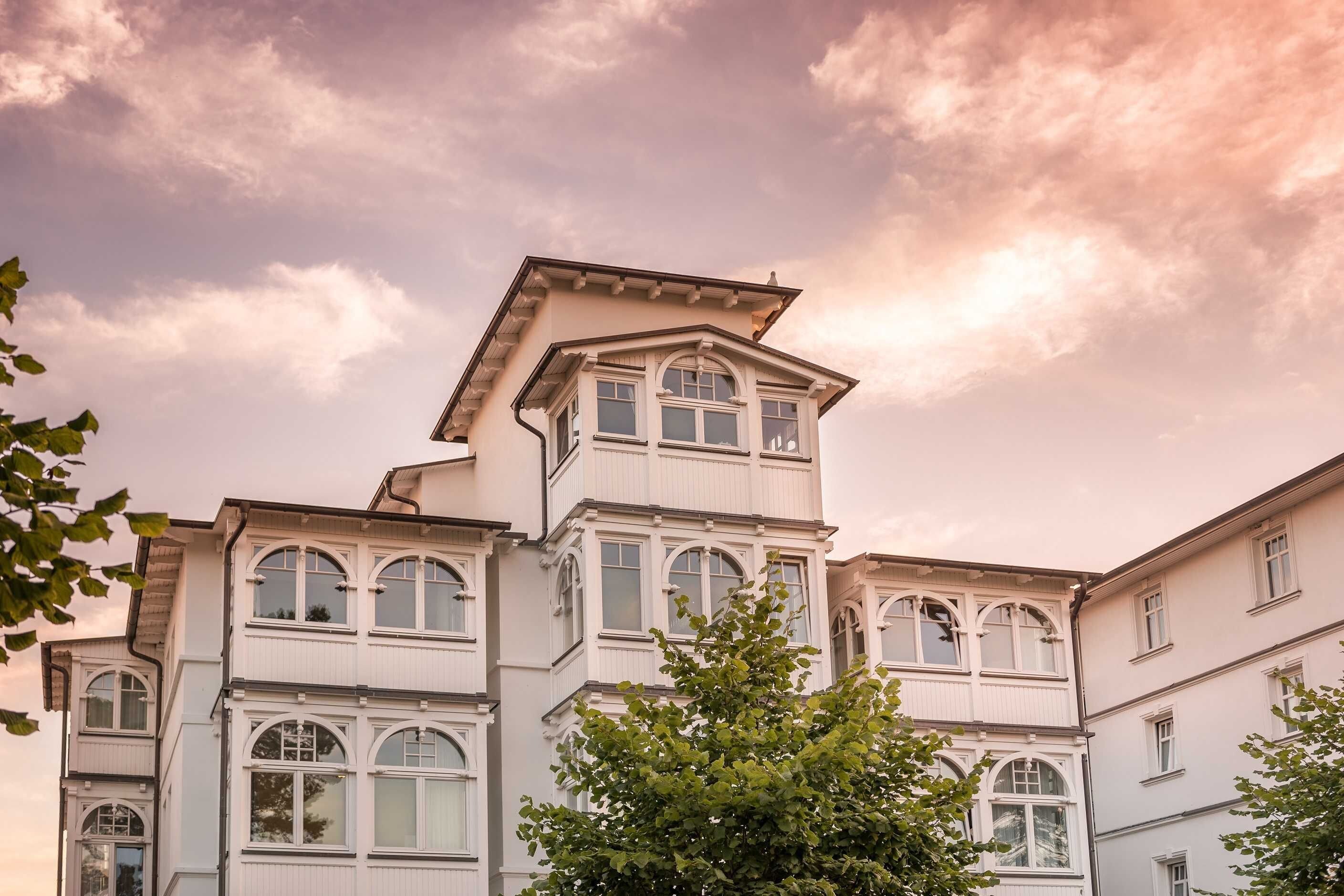 A multi-story building with a prominent corner section and multiple windows.