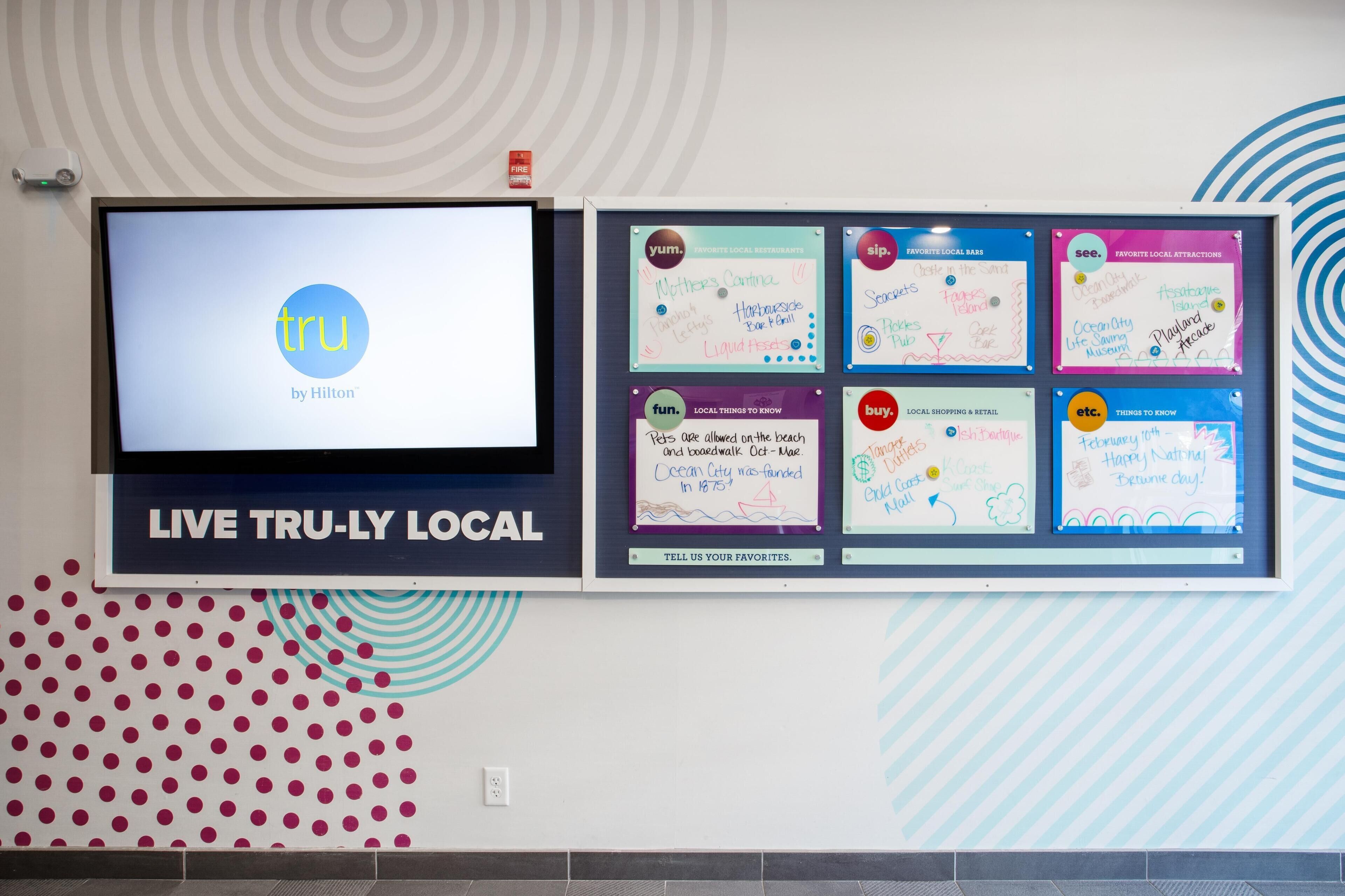 A wall-mounted display with a screen and several information boards.