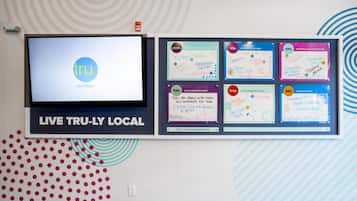 A wall-mounted display with a screen and several information boards.