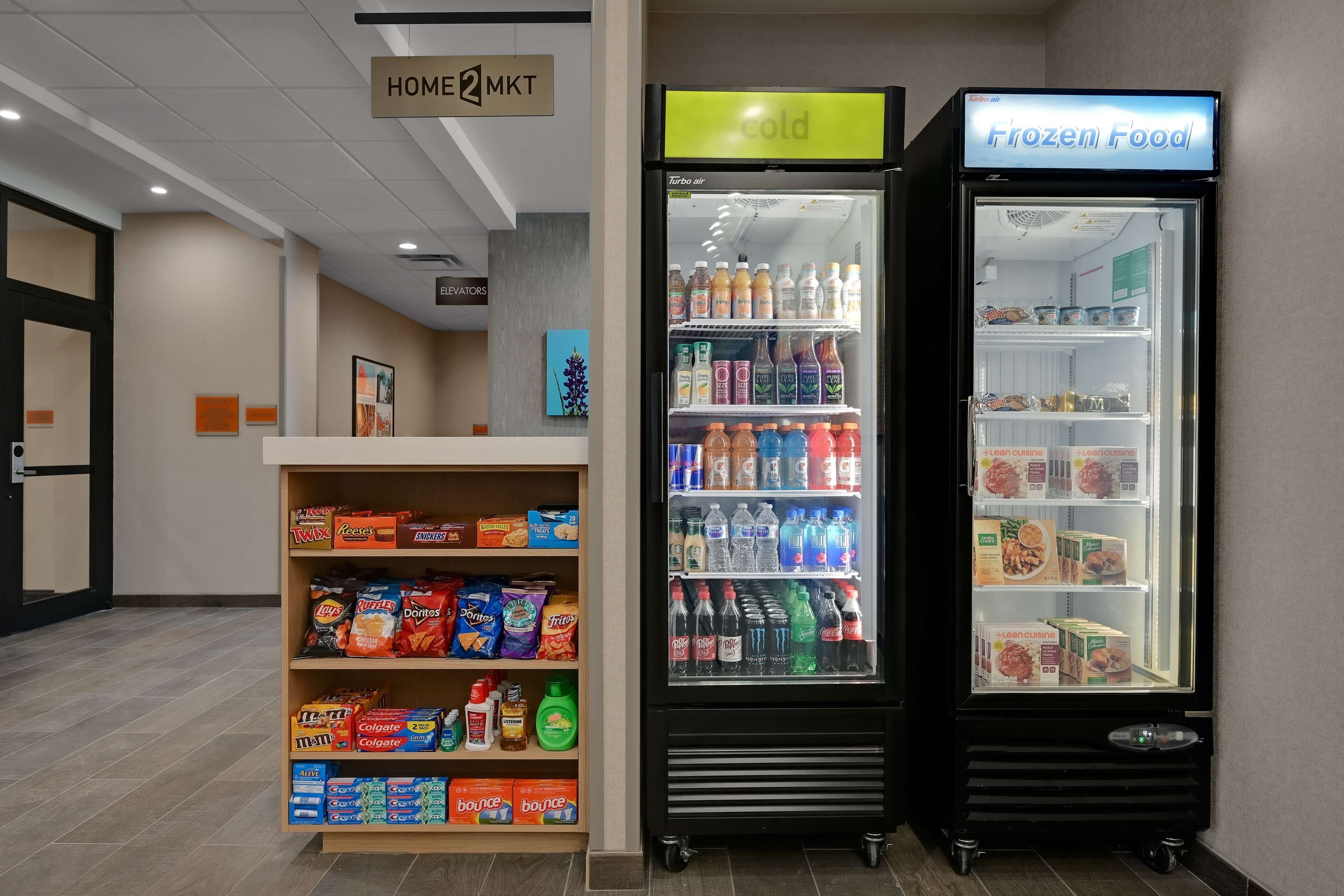 A vending machine area with snacks, drinks, and frozen food options.
