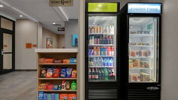 A vending machine area with snacks, drinks, and frozen food options.