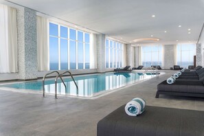 Indoor pool, open 6:00 AM to 11:00 PM, pool loungers - Aleph Doha Residences, Curio Collection by Hilton (Doha)