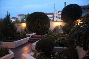 Stroll through the serene garden, surrounded by lush greenery and beautifully trimmed hedges.