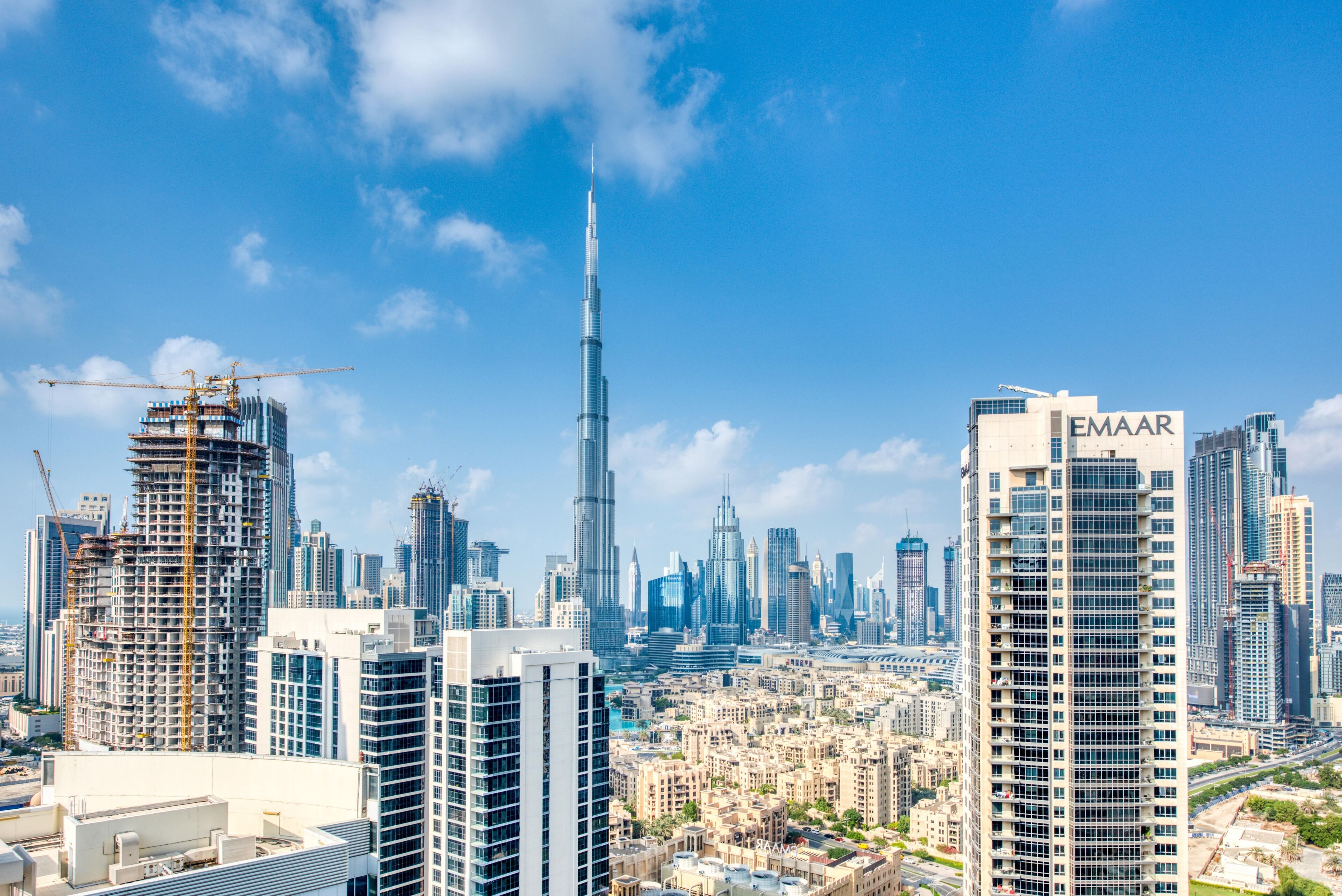 A cityscape with high-rise buildings, including a prominent tower and a building labeled "EMAAR".