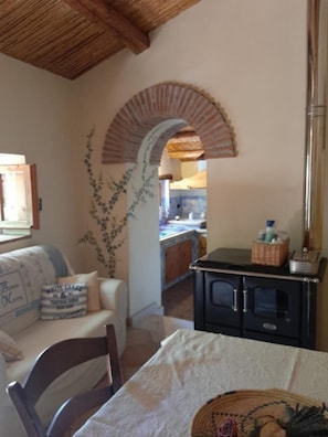 Relax in this inviting space with a comfortable sofa, kitchen area, and cozy dining table.