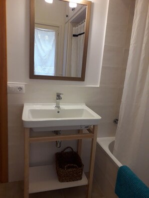 Bathtub, hair dryer, towels, soap
