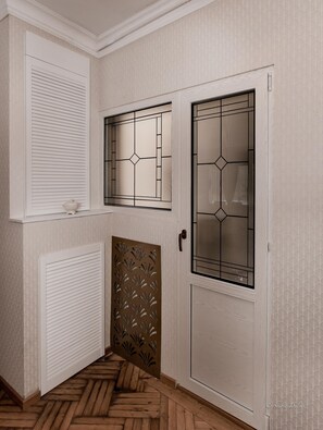 Stunning hallway with doors featuring geometric patterns and a herringbone floor.
