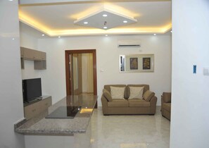 Apartment | Living room | 30-inch TV with satellite channels - Amazing one Bedroom Apartment in Amman, Elwebdah 4 (Amman)