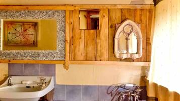 A bathroom with a sink, mirror, and a towel rack.