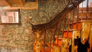 A rustic wooden staircase with a stone wall background. - Unique Fairytale Farmhouse Near Galway (Corrandulla)