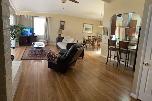 Open concept, Vaulted living room with floor to ceiling windows red rock views.