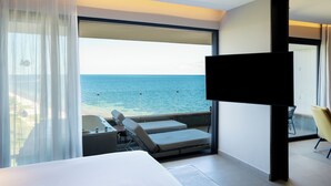 Une chambre d’hôtel moderne dotée d’un grand balcon, d’un lit, d’une télévision et offrant une vue sur la mer.