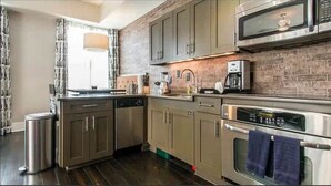 A modern kitchen with stainless steel appliances, a dishwasher, and a coffee maker. - Enjoy a Pre-Holiday vacation in Historic Savannah (Savannah)