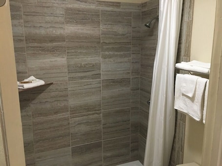 Combined shower/tub, towels. Whispering Creek Lodging & RV Resort