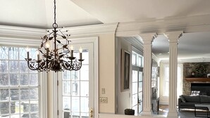 A spacious kitchen with a wooden table and bench, a chandelier, and large windows. - Over Sized Colonial on Private Road.  (Pound Ridge)