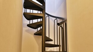 A spiral staircase with multiple levels, leading to an upper floor. - Michela 4  by Theater Home, with private garden and lake view (Tignale)