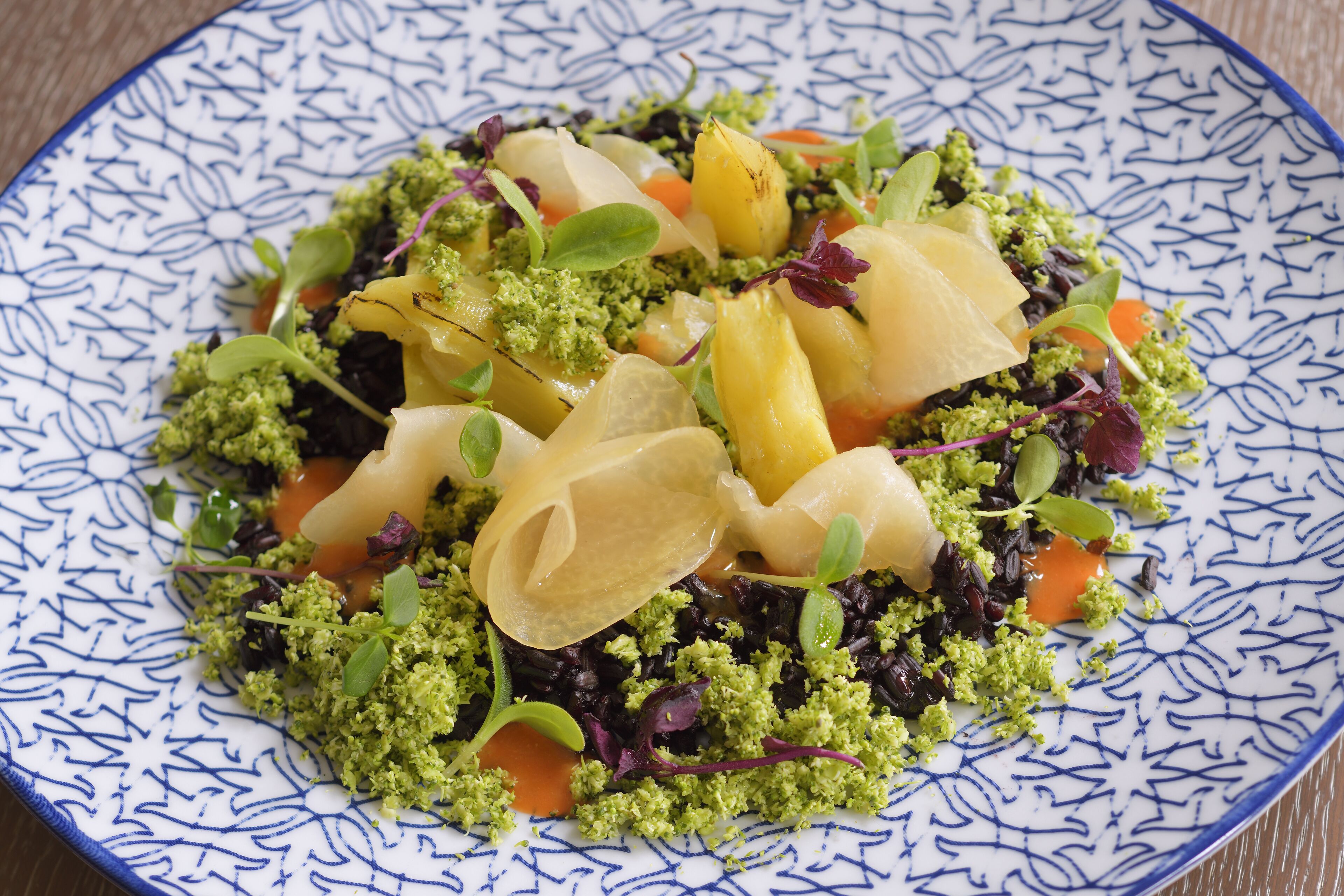 A plate of food with various vegetables and garnishes.