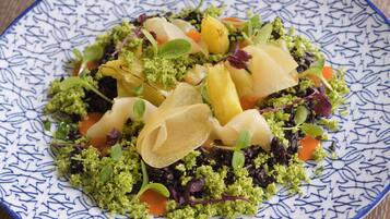 A plate of food with various vegetables and garnishes.