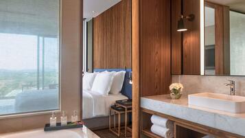Une salle de bain moderne avec un grand lavabo, un miroir et un meuble-lavabo en bois.