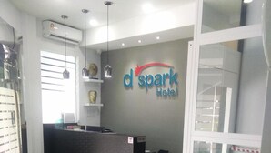 A reception area with a desk, chairs, and a logo for 'd spark Hotel'. - D'Spark Hotel Bayu Tinggi (Klang)