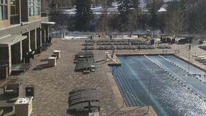 A hotel with a pool, lounge chairs, and a view of snow-capped mountains. - Luxury One Bedroom Westin Riverfront Villa (Avon)