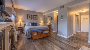 A bedroom with a bed, bedside tables, lamps, and a bench. - Lake Aspen Landing by Innsbrook Vacations! (Innsbrook)