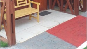 A wooden building with a covered porch, a bench, and a door marked with the number 7. - Pousada Ilson (Olímpia)