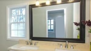 A bathroom with a large mirror, two sinks, and a window. - Quiet sunsets on Lanier (Oakwood)