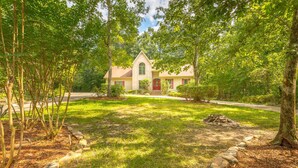 A house with a stone facade, a red door, and a small front porch. - 12 Bedroom XL HotTub 2 HOUSES~44ppl (Lookout Mountain)