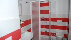 A bathroom with a shower, toilet, and sink. - Sorrento deluxe Balcony (Sorrento)