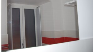 A hallway with a door leading to a room. The walls are white, and there is a red accent at the bottom. - Sorrento deluxe Balcony (Sorrento)