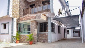 A building with a stone facade, a balcony, and potted plants. - Mitos Luxury Suites (Lagos)