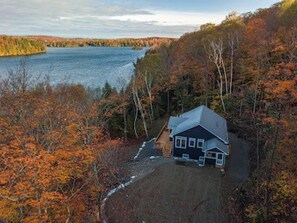Escape to a secluded cabin surrounded by a wooded area and a serene lake.